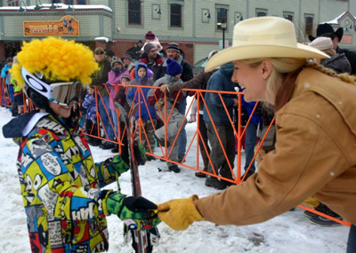 Lindsay from F.M. Light hands a skier a sheriff's badge in Steamboat