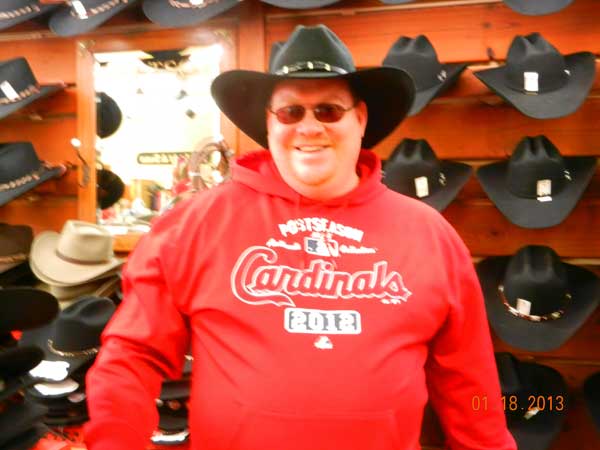Pictures from Merrie - Customer in F.M. Light and Sons admiring the hat wall full of cowboy hats in Steamboat Springs, CO