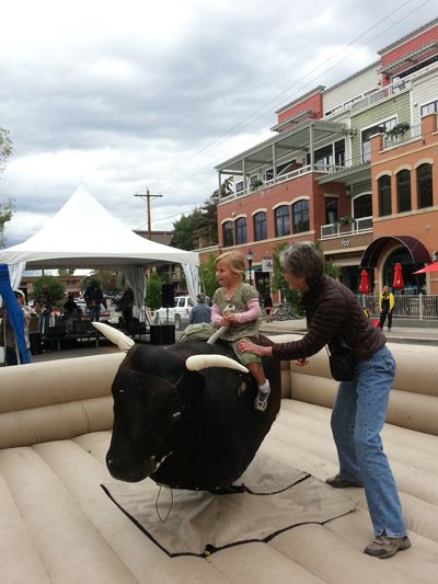 Western Events in Steamboat: Little Girl Riding a Mechanical Bull at Yampa Live Event