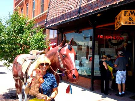 Customer Cathy Posing with her new Cowboy Boots and Lightning the Horse outise F.M. Light and Sons - Western Wear Store in Steamboat Springs, CO