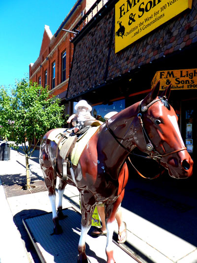 A Babies' First Trip to Steamboat | Riding on Lighting the Horse Outside F.M. Light and Sons in Steamboat Springs, CO | Western Wear for Over 100 Years