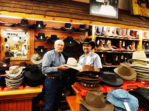 John Fischer (of the Yampa Valley Boys) recieves his hat from Del Lockhart, in a drawing offered by F.M. Light and Sons and Stetson | Western Wear in Colorado